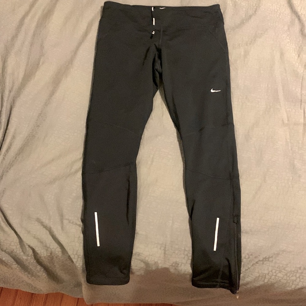 Nike Dri-Fit L running leggings with zippers at the bottom